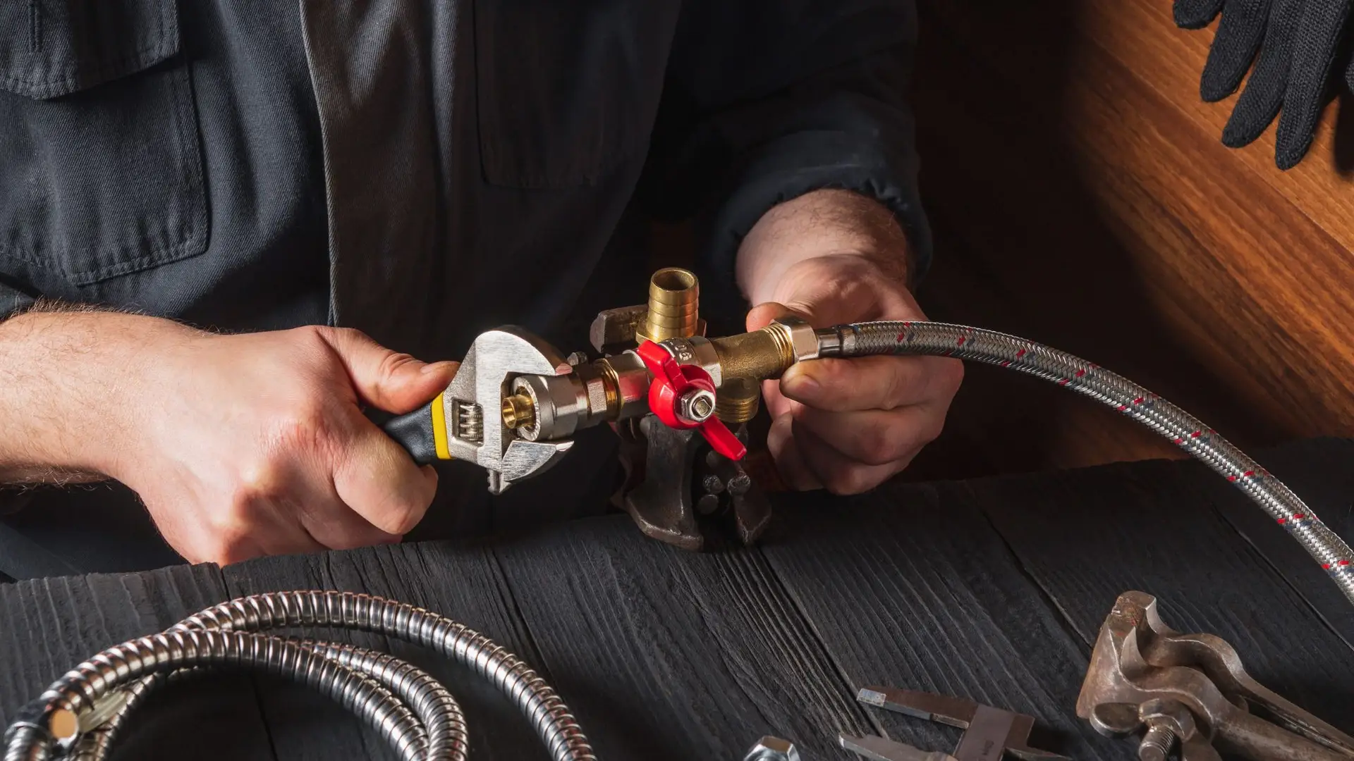 Plumber tightening valve with wrench and flexible hose.