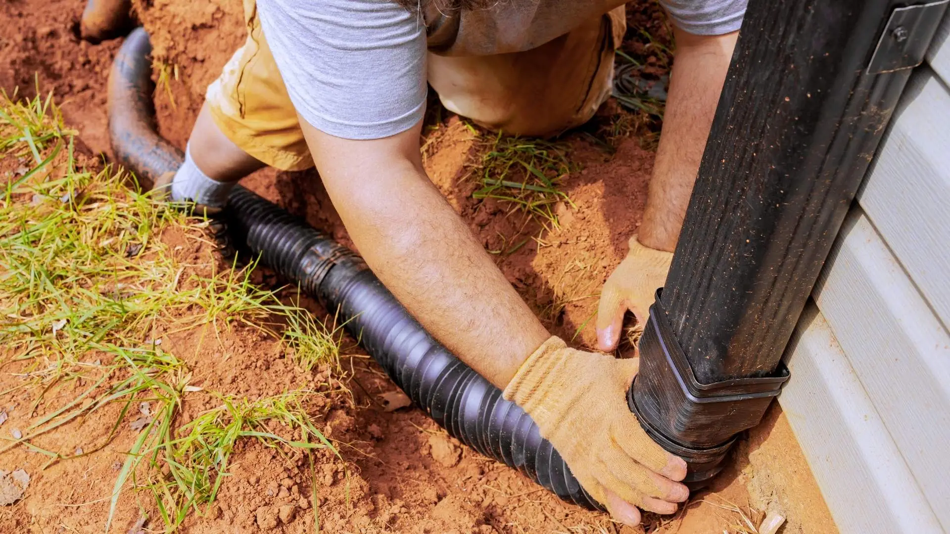 Installing black drainage pipe outdoors