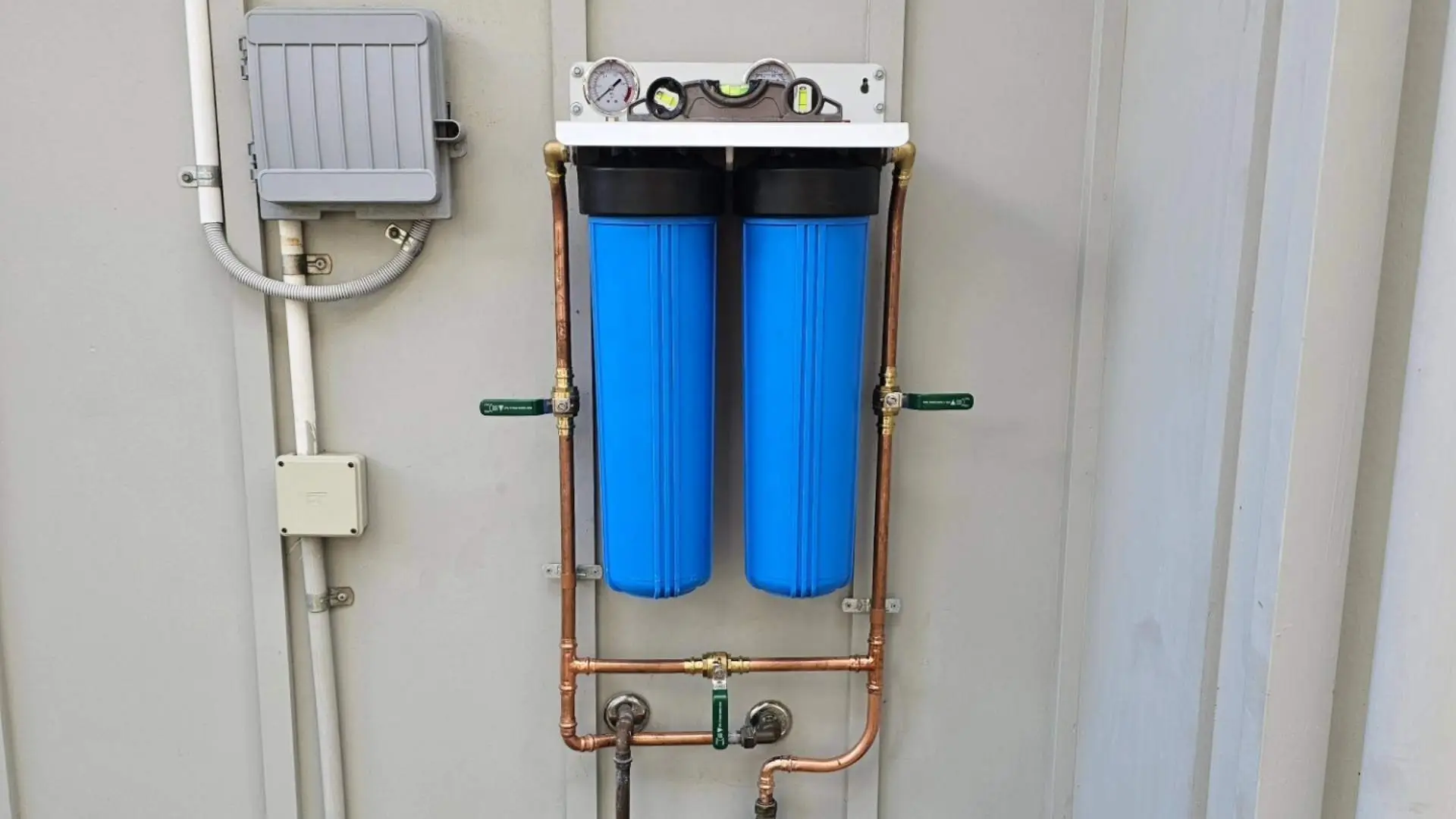 Dual blue water filtration system on wall