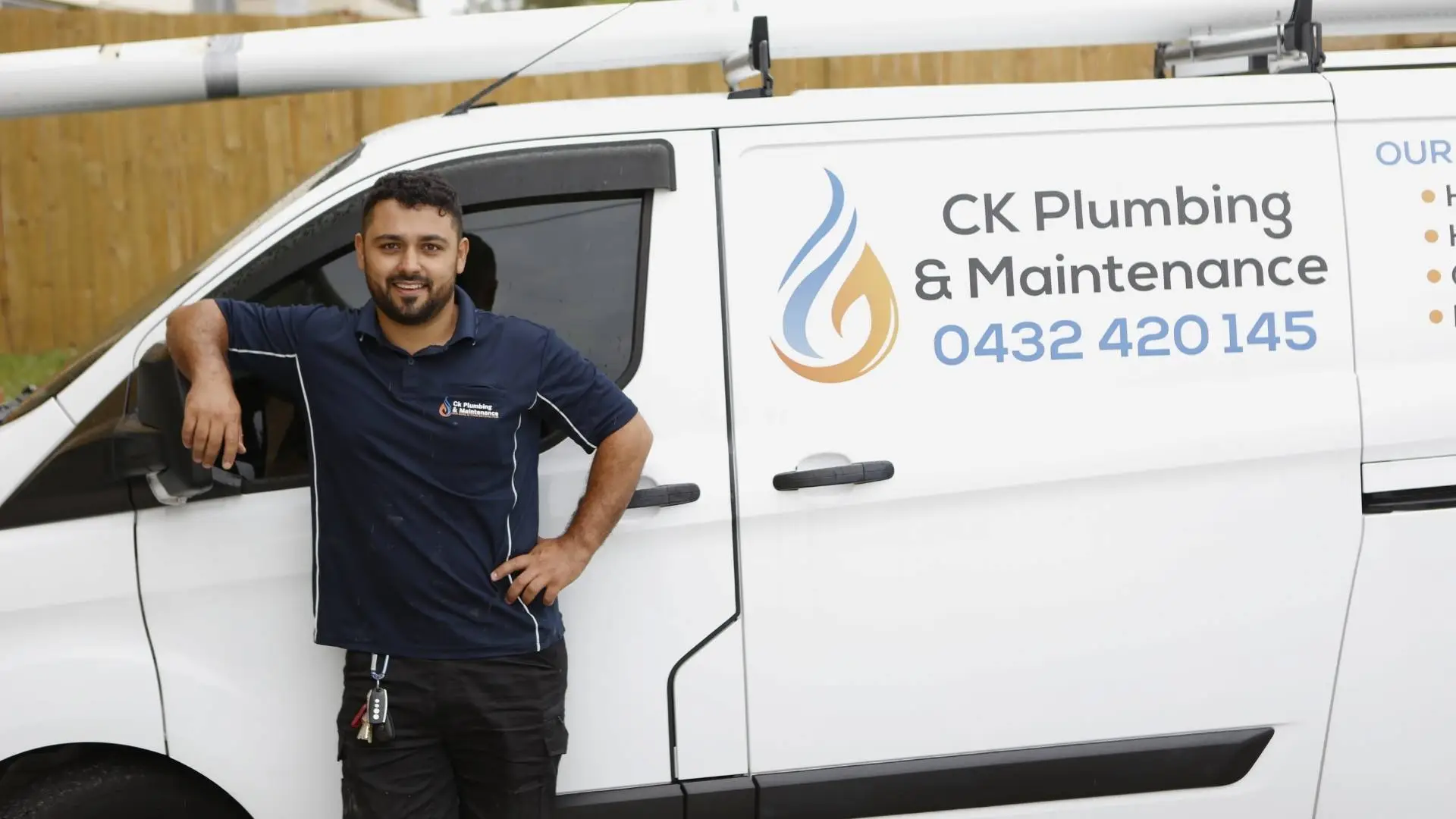 Plumber standing by CK Plumbing van