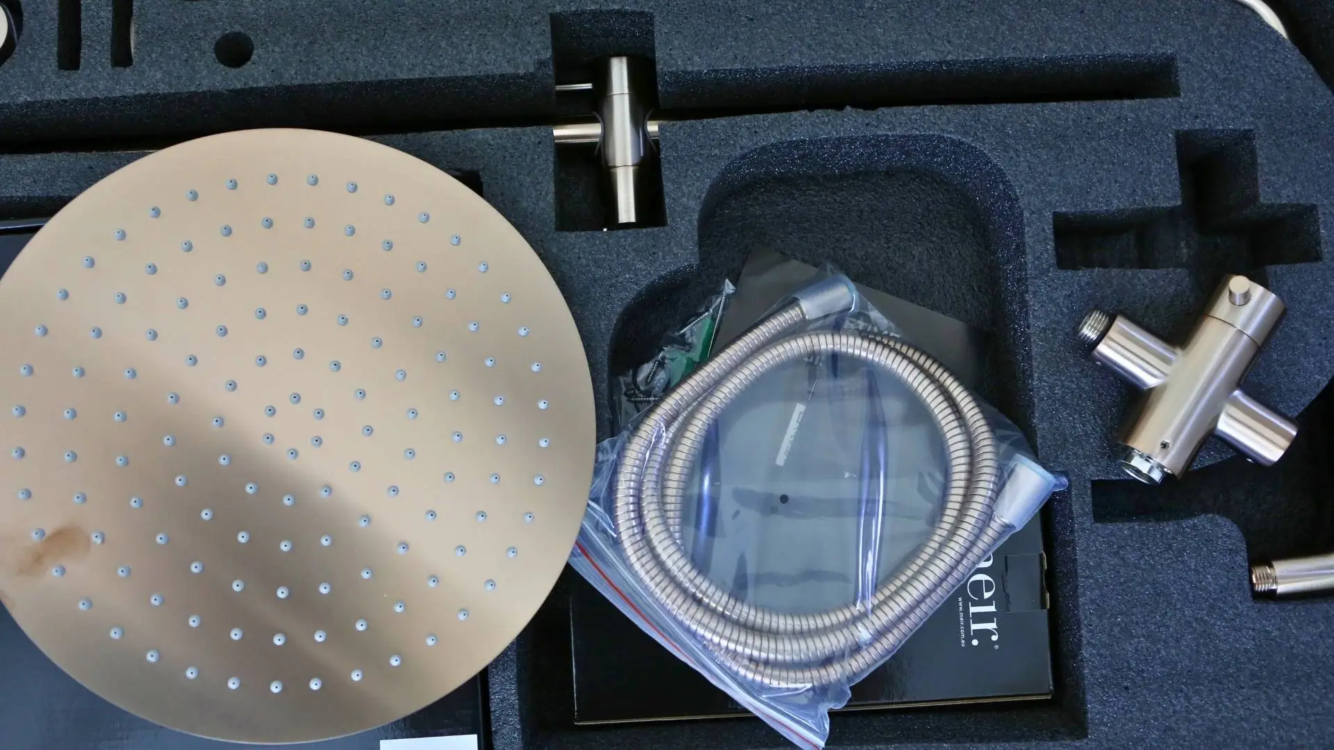 Showerhead set with hose and connector parts.