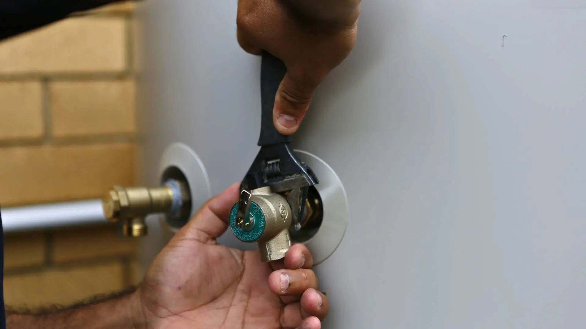 Adjusting water heater valve with wrench